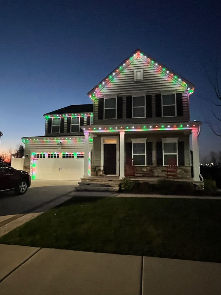Festively decorated house with colorful Christmas lights at twilight.